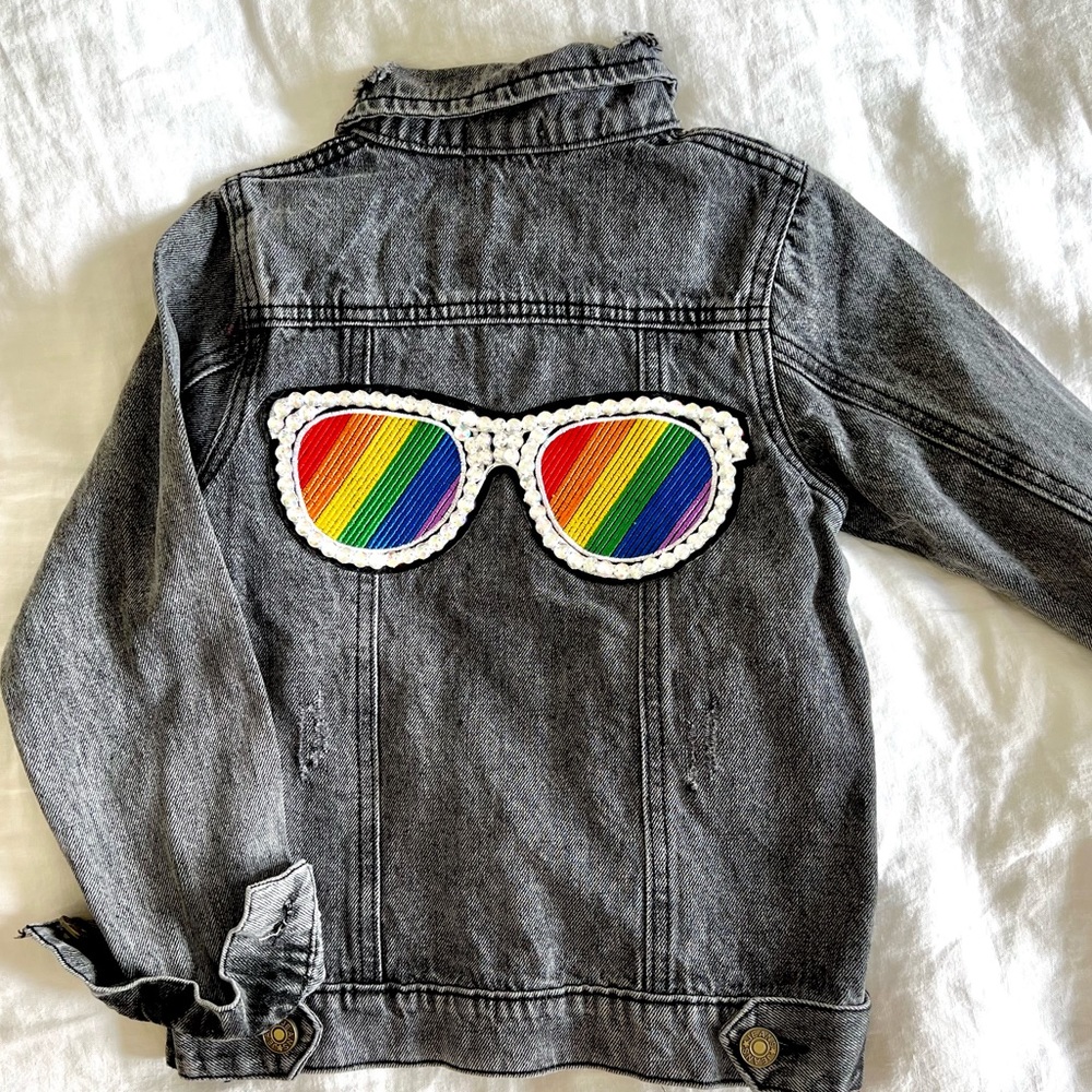 Lola and the boys girls dark denim jacket with rainbow jeweled sunglasses.